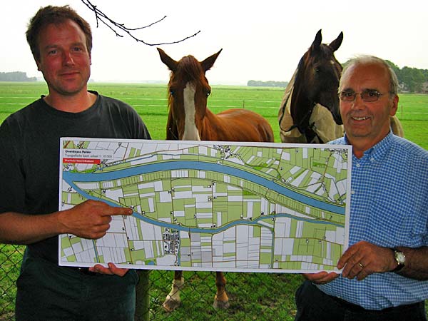 
                Overdiepse polder farmer Stan Fleereckers points to the location on a map where he's standing. In a few years, everything between the two forks of the river will be allowed to occasionally flood. The  farm will be demolished and rebuilt atop a "terp."
                                    (Rico Gagliano)
                                