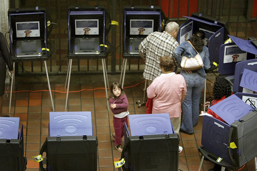 
                    Voters using touch screen voting machines during the first day of early voting in the 2008 Miami, Fla., presidential primary.
                                            (Joe Raedle/Getty Images)
                                        