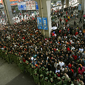 Chinese railway passengers wait to board 