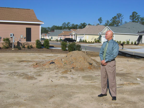 
                Gary Drejza stands on the lot where his house was supposed to be built. He was selling houses in the development as well.
                                    (Steve Tripoli / Marketplace)
                                