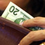 A customer prepares to spend her money.