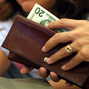 A customer prepares to spend her money. 