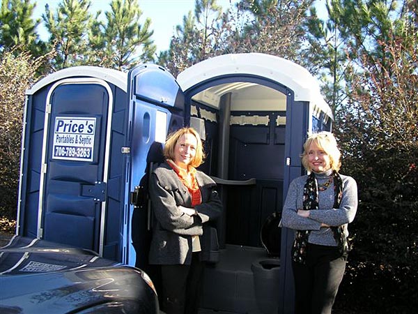 
                Sisters Brenda Zareie, left, and Barbara Fogg with the porta-potties they brought to the Athens Family Dental Center in Athens, Ga. as a water-saving measure.
                                    (Nancy Marshall Genzer)
                                