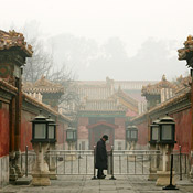 A man walks through Beijing on a polluted day 