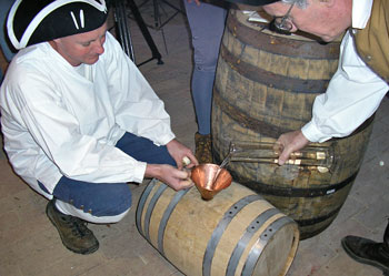 
                Colonial re-enactors make whiskey in Mt. Vernon, Va.
                                    (Hillary Wicai / Marketplace)
                                