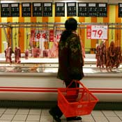 Customer shops for meat at market in China 