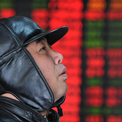 A Chinese investor looks up at the price board 