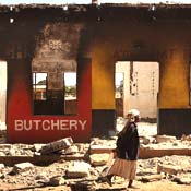 Woman passes butcher shop in Kenya 