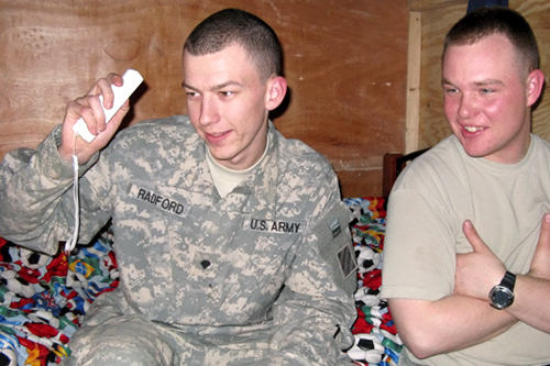 
                    Specialist Paul Radford from Rock Hill, S.C., enjoys his Nintendo Wii while Specialist Eric Wade, from Clayton, N.C., looks on.
                                            (Adam Allington)
                                        