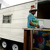 Vanessa Gaten stands in front of her FEMA trailer 