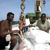 Somali men unload from World Food Program boat 