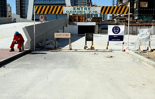 
                A construction worker sits in the sun, at the front of a building at Jumeirah Lake Towers in Dubai on a Friday. Most laborers are given the day off, but some still work.
                                    (Tamara Abdul Hadi)
                                