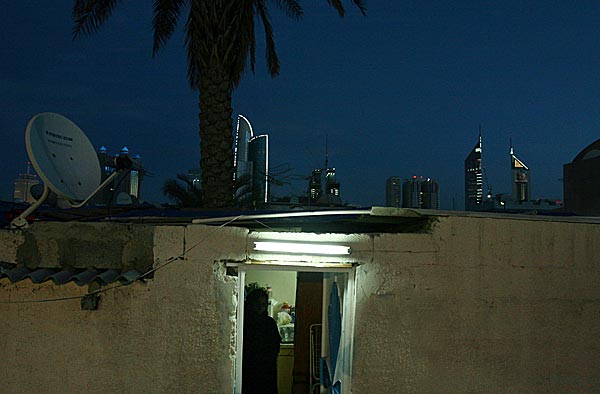 
                The business and residential towers of the new Dubai stand in contrast to a home in the older, poorer neighborhood of Al Satwa. Al Satwa's residents include Emiratis from the Bloushi tribe who have been there for many decades, Iranians who have been in the Emirates for over 60 years, migrant workers mostly from South Asia and even Western ex-pats.
                                    (Tamara Abdul Hadi)
                                