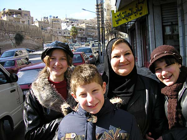 
                From left, Weesnaa, Abdulelah, Ayssir and Taghreed on the streets of Amman, Jordan. Walking is one of the family's favorite things to do together. They love the freedom of going outside (it was too dangerous in Baghdad) and it doesn't cost anything.
                                    (Alisa Roth)
                                