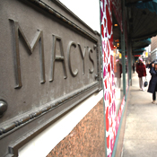 Pedestrians pass a Macy's store 