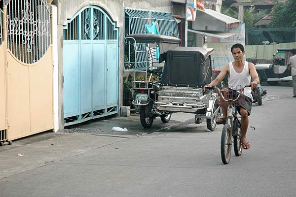 
                Jose Garcia rides home on his bike in Manila, Philippines.
                                    (Scott Tong)
                                