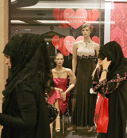
                Emirati women walk past a window display featuring Valentine's Day gifts and lingerie at a mall in Dubai.
                                    (Karim Sahib/AFP/Getty Images)
                                