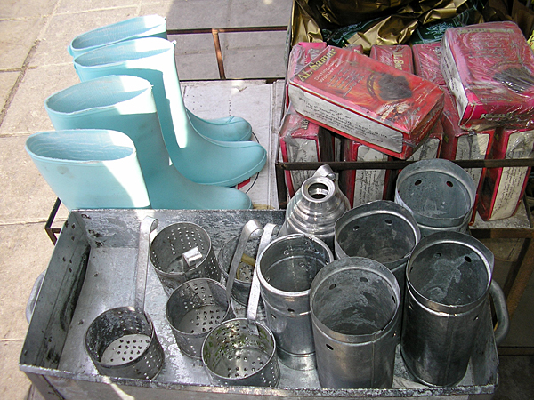 
                Along a road where day laborers wait for work, stores sell supplies that the Egyptians need. Here rubber work boots and parts for water pipes.
                                    (Rana Sweis)
                                