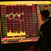 Chinese investor surveys stocks 