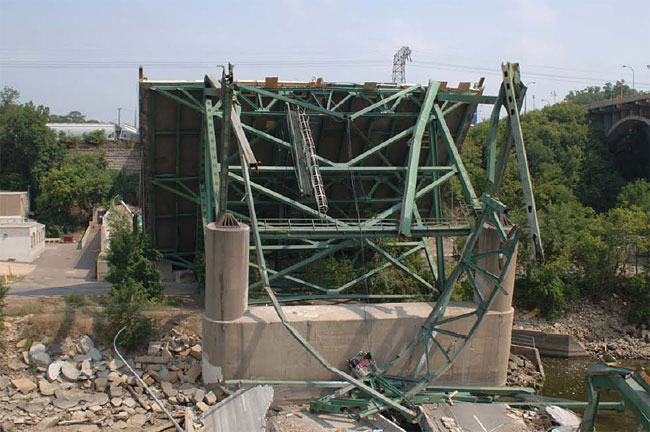 A damaged portion of the deck truss at pier 7, on the north side of the Mississippi River, viewed looking north.