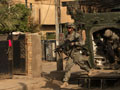 A soldier prepares to search a home