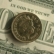 A British pound atop a U.S. dollar 