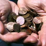 A man holding pennies 
