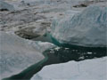 An aerial view of icebergs floating in Greenland