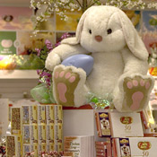 Easter bunny sits on a candy sale 