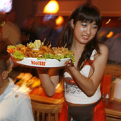 Waitress serving food at Hooters Beijing 