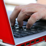 A laptop user typing 