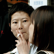 A smoker takes a drag in a Hong Kong street 