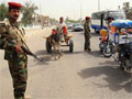 An Iraqi police commando stands guard