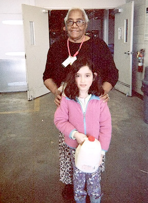 
                    Ms. Shotwell and Kaiah Callahan with a free gallon of milk that will be taken back to Morningstar Baptist Church.
                                            (Mhari Saito)
                                        
