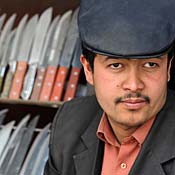 A Chinese Uighur Muslim man waits for customers at his knife shop in the town of Kashgar, in Xinjiang Province.