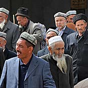 Chinese Uighur Muslims leave a mosque in the town of Kashgar, in Xinjiang Province.
