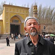 Chinese Uighur Muslim men leave the main mosque in Kashgar, Xinjiang province.