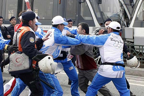 
                Chinese security guards and Turkish police arrest an Uighur Muslim protester during an Olympic torch ceremony in Turkey on April 3, 2008.
                                    (STR/AFP/Getty Images)
                                