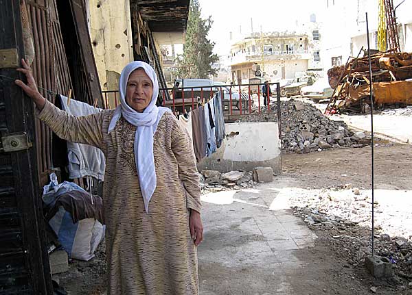 
                A Palestinian woman stands near her ruined home in the devastated refugee camp of Nahr al-Bared in northern Lebanon.
                                    (AFP/Getty Images)
                                