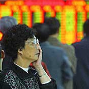 A worried investor views stock indexes 