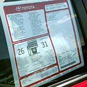 Car window sticker displays mileage estimate 