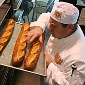 baker checks bread 