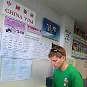 Tourist waits to inquire about China entry visa 