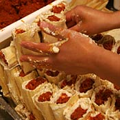 Hands making tamales 