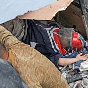Rescuers try to get a boy from school rubble 