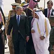 President Bush speaks with Saudi King Abdullah after walking off Air Force One during the arrival ceremony at King Khaled International Airport in Riyadh on May 16, 2008.