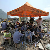 Earthquake survivors and rescue workers in shelter 