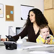 Working mother with child in home office 