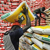 Workers handle sacks of rice in Ivory Coast 