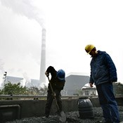 Power plant workers in China collects coal 